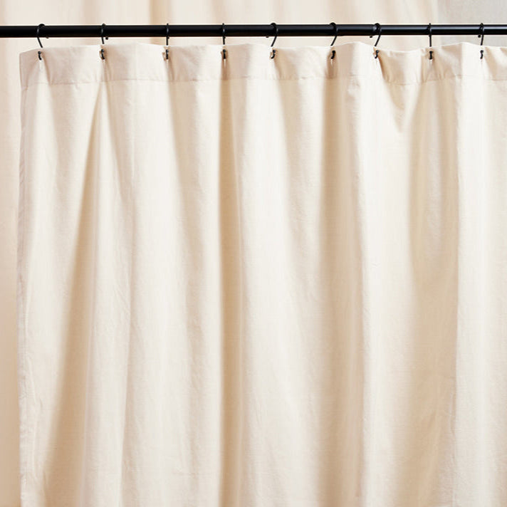 The Loving Liner, a non-toxic shower liner made with organic cotton, a non-gmo plant based interlayer hung on shower rings.
